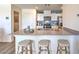 Open kitchen layout with bar stool seating, quartz countertops, and stainless steel appliances at 6109 Aster Garden St # 159, North Las Vegas, NV 89081