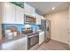 Modern kitchen featuring white cabinets, stainless steel appliances, and light countertops at 6109 Aster Garden St # 159, North Las Vegas, NV 89081