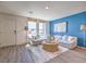 Bright living room with stylish furnishings, natural light, and wood-look laminate flooring at 6109 Aster Garden St # 159, North Las Vegas, NV 89081