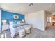 Relaxing main bedroom features a calming blue accent wall, carpeting, and natural light at 6109 Aster Garden St # 159, North Las Vegas, NV 89081