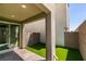 This backyard features brick-paved patio area and small synthetic lawn section at 649 Tranquil Jade St, Las Vegas, NV 89138