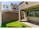 Backyard featuring artificial lawn and brick patio with view of neighborhood at 649 Tranquil Jade St, Las Vegas, NV 89138
