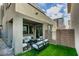 Cozy backyard featuring a covered patio with an outdoor seating area and low-maintenance turf at 649 Tranquil Jade St, Las Vegas, NV 89138