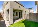 Backyard with small patch of green artificial lawn and brick paved patio at 649 Tranquil Jade St, Las Vegas, NV 89138