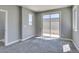 Neutral bedroom with sliding glass door to balcony, large windows, and plush carpeting at 649 Tranquil Jade St, Las Vegas, NV 89138