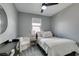 Comfortable bedroom featuring a cozy chair, neutral tones, and a ceiling fan at 649 Tranquil Jade St, Las Vegas, NV 89138