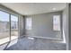 Neutral bedroom with sliding glass door to balcony, large windows, and plush carpeting at 649 Tranquil Jade St, Las Vegas, NV 89138