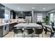 Modern kitchen featuring dark wood cabinets, stainless steel appliances, and an island with seating at 649 Tranquil Jade St, Las Vegas, NV 89138