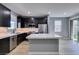 Bright, modern kitchen with stainless appliances and center island and light, modern flooring at 649 Tranquil Jade St, Las Vegas, NV 89138