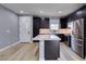 The modern kitchen features a center island, sleek black cabinets, and stainless steel appliances at 649 Tranquil Jade St, Las Vegas, NV 89138