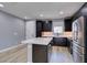 This modern kitchen features stainless appliances, a center island, and sleek black cabinets at 649 Tranquil Jade St, Las Vegas, NV 89138