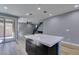 Open-concept kitchen layout with island and view to living area and sliding patio door at 649 Tranquil Jade St, Las Vegas, NV 89138