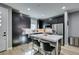 Modern kitchen featuring dark cabinets, stainless steel appliances, and a large island with seating at 649 Tranquil Jade St, Las Vegas, NV 89138