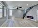 Stylish living space featuring modern staircase, contemporary fireplace, and large windows at 649 Tranquil Jade St, Las Vegas, NV 89138
