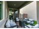 Relaxing covered patio featuring comfortable lounge seating, a modern fire pit and sliding door entry at 649 Tranquil Jade St, Las Vegas, NV 89138