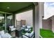 Comfortable covered patio with cushioned seating, a fire pit, easy access to indoor living spaces, and a turf yard at 649 Tranquil Jade St, Las Vegas, NV 89138