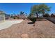 Spacious backyard featuring hardscape, desert landscaping, and a basketball hoop at 6529 Bradford Ln, Las Vegas, NV 89108