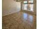 Bright bedroom featuring neutral walls, tile floors, and large windows at 6529 Bradford Ln, Las Vegas, NV 89108