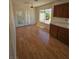 Well-lit kitchen featuring wood cabinets, laminate floors, and a bright window at 6529 Bradford Ln, Las Vegas, NV 89108