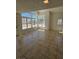 Bright living room featuring neutral walls, tile floors, and lots of windows at 6529 Bradford Ln, Las Vegas, NV 89108