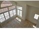 Bright living room featuring large windows, tile flooring, and natural light at 6529 Bradford Ln, Las Vegas, NV 89108