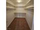 Walk-in closet with installed shelving and carpet flooring at 6529 Bradford Ln, Las Vegas, NV 89108