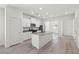 Bright open kitchen with a center island, stainless appliances, and sleek white cabinets at 6725 Lotus Vista Ct, Las Vegas, NV 89156
