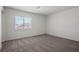 Bright, carpeted bedroom featuring a window with scenic neighborhood views at 6772 Violet Cascade Ave, Las Vegas, NV 89156