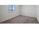 Carpeted bedroom with a window offering views of the neighborhood at 6772 Violet Cascade Ave, Las Vegas, NV 89156