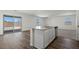 The open kitchen features stainless steel appliances, white cabinets, and glass sliding doors at 6772 Violet Cascade Ave, Las Vegas, NV 89156