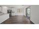 The open kitchen features stainless steel appliances, white cabinets, and glass sliding doors at 6772 Violet Cascade Ave, Las Vegas, NV 89156