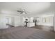 The open-concept living space seamlessly integrates carpeted and wood-look vinyl flooring at 6772 Violet Cascade Ave, Las Vegas, NV 89156