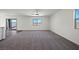 Spacious living room features neutral carpeting, a modern ceiling fan, and bright natural light at 6772 Violet Cascade Ave, Las Vegas, NV 89156