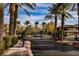Gated community entrance, enhanced by lush landscaping and palm trees at 6868 Sky Pointe Dr # 1112, Las Vegas, NV 89131