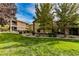 Beautifully landscaped apartment complex with lush green lawn, mature trees, and patios at 6868 Sky Pointe Dr # 1112, Las Vegas, NV 89131