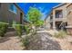 Well-maintained apartment buildings featuring private balconies and landscaped walkways at 6868 Sky Pointe Dr # 1112, Las Vegas, NV 89131