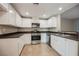 This updated kitchen offers stainless steel appliances, white cabinets, and sleek countertops at 6868 Sky Pointe Dr # 1112, Las Vegas, NV 89131