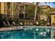 Inviting community pool with comfortable lounge chairs and lush landscaping at 6868 Sky Pointe Dr # 1112, Las Vegas, NV 89131