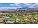 Beautiful aerial view showcasing the lush green golf course and scenic mountain views of Summerlin, Nevada at 701 Peachy Canyon Cir # 201, Las Vegas, NV 89144