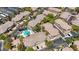 Aerial view of condo community featuring a swimming pool, trees, and parking at 701 Peachy Canyon Cir # 201, Las Vegas, NV 89144