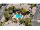 An aerial view showcases a resort-style pool, palm trees, and beautiful landscaping at 701 Peachy Canyon Cir # 201, Las Vegas, NV 89144