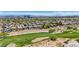 Expansive aerial view of a neighborhood, lush golf course, and mountain views in Summerlin, Las Vegas at 701 Peachy Canyon Cir # 201, Las Vegas, NV 89144