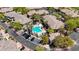 An aerial view showcases a community pool, palm trees, and well-maintained landscaping at 701 Peachy Canyon Cir # 201, Las Vegas, NV 89144