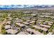 Breathtaking aerial view of residential condos, lush landscaping, and mountain scenery at 701 Peachy Canyon Cir # 201, Las Vegas, NV 89144