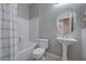 Bright bathroom features a shower over the tub, white pedestal sink and modern fixtures at 701 Peachy Canyon Cir # 201, Las Vegas, NV 89144
