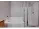Bathroom featuring a shower stall with glass doors and a soaking tub with tile surround at 701 Peachy Canyon Cir # 201, Las Vegas, NV 89144