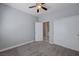 Bedroom with a ceiling fan, closet, carpet floors and a door connecting to the laundry, designed for optimal functionality at 701 Peachy Canyon Cir # 201, Las Vegas, NV 89144