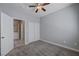 Bedroom with a ceiling fan, closet, carpet floors and a door connecting to the laundry, designed for optimal functionality at 701 Peachy Canyon Cir # 201, Las Vegas, NV 89144