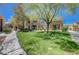 Exterior shot of the condo complex, showcasing green lawns and walkway at 701 Peachy Canyon Cir # 201, Las Vegas, NV 89144