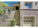 View of the condo's attached garage and stone-accented facade at 701 Peachy Canyon Cir # 201, Las Vegas, NV 89144